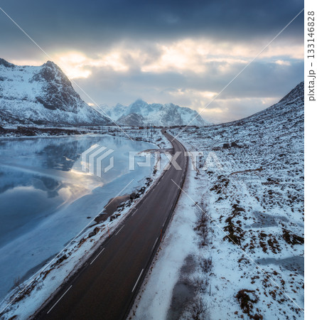 Aerial view of winter road at sunset. Lofoten islands, Norway Aerial view of winter road at sunset. Lofoten islands, Norway 133146828