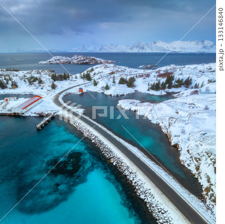 Aerial view of road, island in snow, rorbu, sea, bridge 133146840