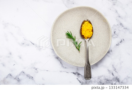 Yuzu caviar is pearly, on a spoon, top view, light background, no people. Yuzu caviar is pearly, on a spoon, top view, light background, no people. 133147334