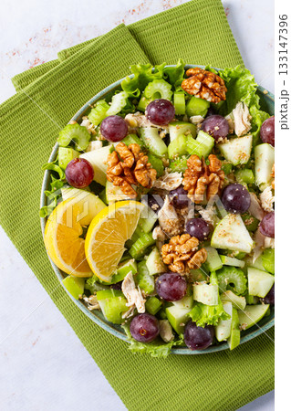Fresh Waldorf salad, celery stalk with chicken, apple and walnuts, grapes, herbs, homemade, without people, Fresh Waldorf salad, celery stalk with chicken, apple and walnuts, grapes, herbs, homemade, without people, 133147396