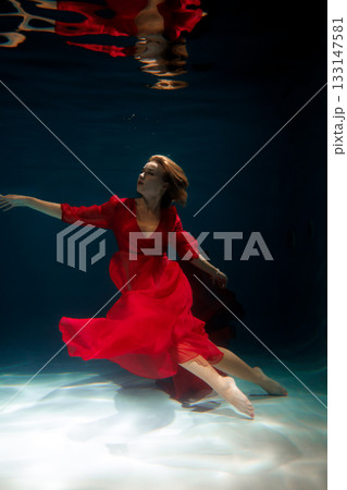 Tranquil marine setting featuring poised figure with floating Tranquil marine setting featuring poised figure with floating 133147581