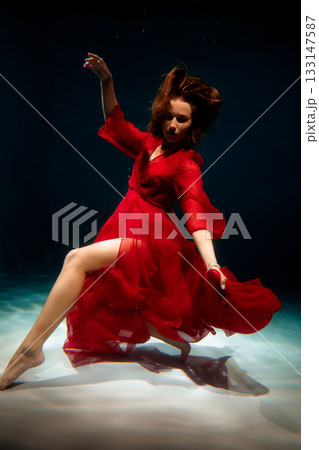 Underwater scene depicts striking ballet with flowing fabric 133147587