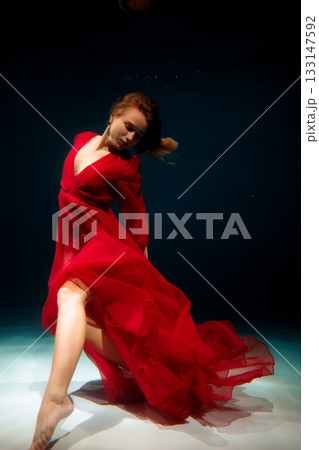 Serene aquatic dancer with flowing scarlet attire performs Serene aquatic dancer with flowing scarlet attire performs 133147592