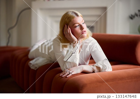 Elegant woman relaxing, Whitehaired lady in tranquil setting 133147648
