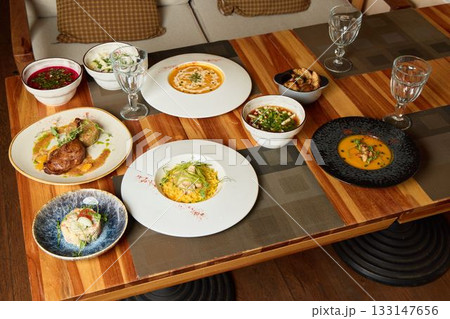 A Delicious Culinary Spread Presented on an Elegant Dining Table for Everyone to Enjoy A Delicious Culinary Spread Presented on an Elegant Dining Table for Everyone to Enjoy 133147656