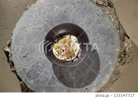 An Elegant Artistic Culinary Presentation Displayed on a Beautiful Natural Stone Base An Elegant Artistic Culinary Presentation Displayed on a Beautiful Natural Stone Base 133147717