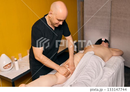 Experience a Professional Massage Therapy Session Set in a Tranquil and Relaxing Environment 133147744