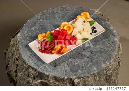A Colorful Fruit Platter on a Beautiful Natural Stone Base Perfect for Any Occasion 133147757