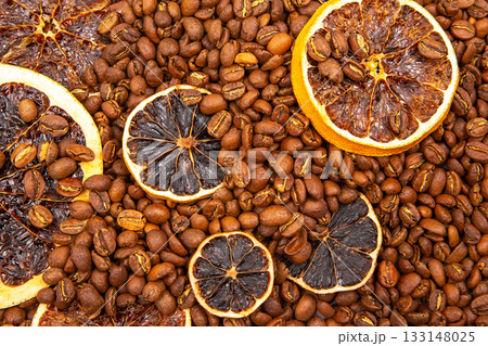 Artistic food photography showcasing dried orange wheels atop a sea of roasted coffee beans Artistic food photography showcasing dried orange wheels atop a sea of roasted coffee beans 133148025