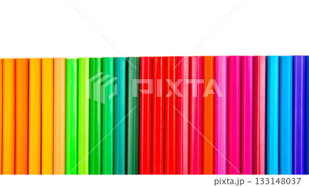 Brightly colored pencils in a wavy row against a white surface. Brightly colored pencils in a wavy row against a white surface. 133148037