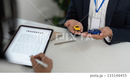 Insurance Consultation. Professional agent discussing car insurance options with clients. 133148455