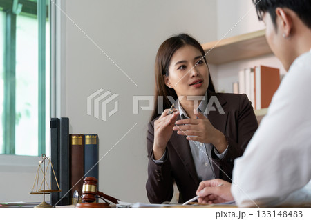 Legal Advice. A lawyer providing guidance to a client in a modern office. Legal Advice. A lawyer providing guidance to a client in a modern office. 133148483