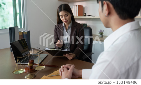 Legal Consultation. Lawyer presenting contract details to a client with a laptop. Legal Consultation. Lawyer presenting contract details to a client with a laptop. 133148486