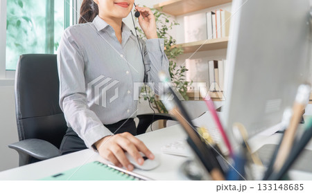 Remote Work. Young professional woman using headset for virtual customer support. Remote Work. Young professional woman using headset for virtual customer support. 133148685