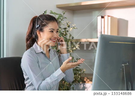 Engaged Customer Service Agent Assisting Clients with Headset 133148686