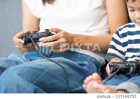Family Gaming Time. Mother and child bonding over video games at home. 133148793
