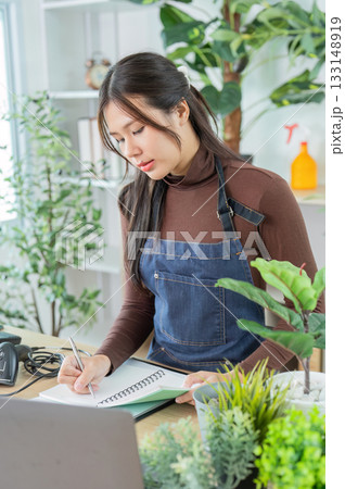 Sustainable Lifestyle. Young woman planning eco-friendly gardening at home office. 133148919