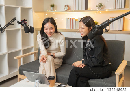 Podcasting. Two women enjoying a fun moment while recording a podcast. Podcasting. Two women enjoying a fun moment while recording a podcast. 133148981