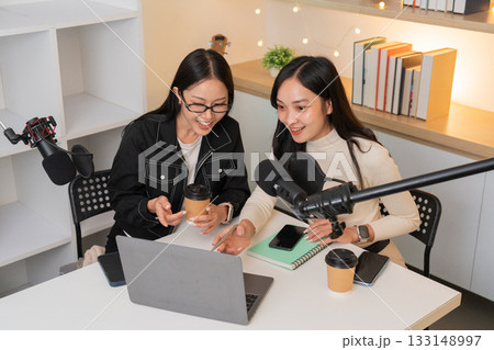 Podcasting Duo Engaging in Digital Content Creation 133148997