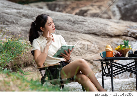 Creative Thinking. Young woman pondering ideas while journaling outdoors. Creative Thinking. Young woman pondering ideas while journaling outdoors. 133149200