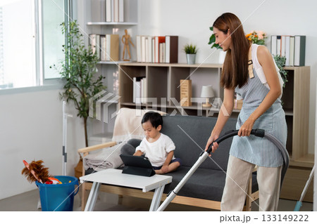 Family Bonding: Mother Cleaning While Child Engages with Tablet Family Bonding: Mother Cleaning While Child Engages with Tablet 133149222