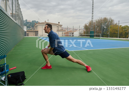 Athlete In Mid Lunging Stretch On Tennis Court For Fitness And Training 133149277
