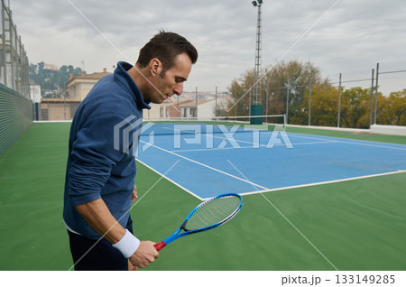 Focused Man Preparing To Play Tennis On Outdoor Court With Racket Focused Man Preparing To Play Tennis On Outdoor Court With Racket 133149285