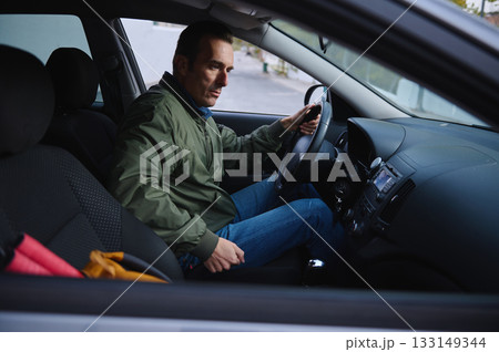 Man Driving Car Inside Vehicle With Focused Expression In A Casual Green Jacket Man Driving Car Inside Vehicle With Focused Expression In A Casual Green Jacket 133149344