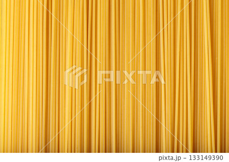 Raw Spaghetti Noodles Creating Culinary Background Macro View Raw Spaghetti Noodles Creating Culinary Background Macro View 133149390