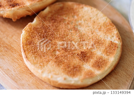 Toasted Burger Buns on Wooden Cutting Board 133149394
