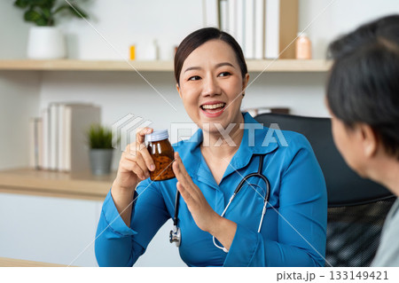 Doctor discussing medication with a patient in a healthcare setting Doctor discussing medication with a patient in a healthcare setting 133149421