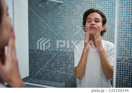 Teenage Boy Skincare Routine In Bathroom Mirror, Reflective Moment Of Self Care Teenage Boy Skincare Routine In Bathroom Mirror, Reflective Moment Of Self Care 133150144