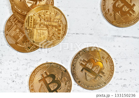Top down view, golden commemorative BTC - bitcoin cryptocurrency - coins scattered on white stone board, closeup detail Top down view, golden commemorative BTC - bitcoin cryptocurrency - coins scattered on white stone board, closeup detail 133150236