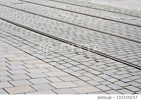 Detail on steel tram rail tiled stone floor around 133150237