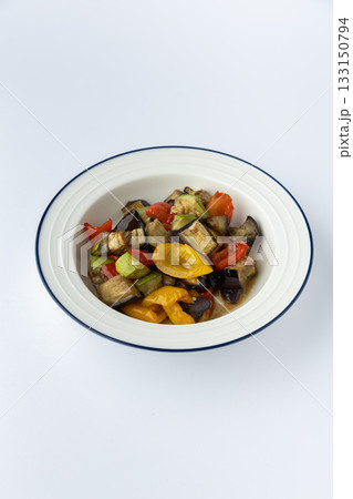 Roasted eggplant and bell pepper medley with zucchini and tomatoes, studio isolated 133150794