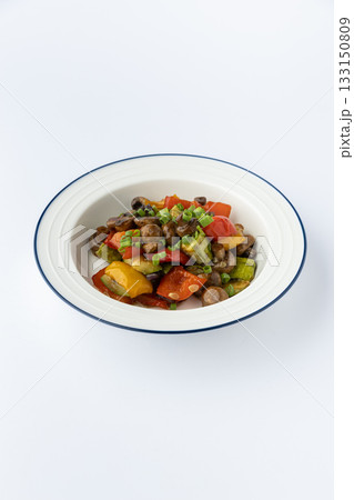 Sauteed mushrooms with bell peppers and zucchini, garnished with scallions, studio shot 133150809