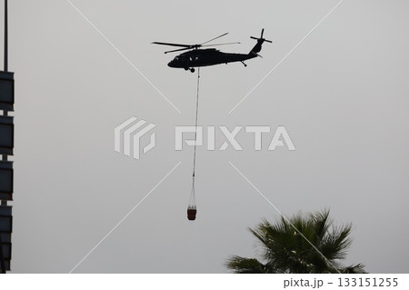 Bucket carrying helicopter. High quality photo 133151255