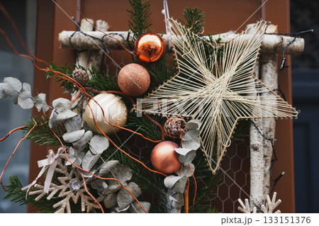 Christmas composition of fir tree branches, balls, and pine cones on the door Christmas composition of fir tree branches, balls, and pine cones on the door 133151376
