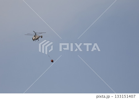 Bucket carrying helicopter. High quality photo Bucket carrying helicopter. High quality photo 133151407