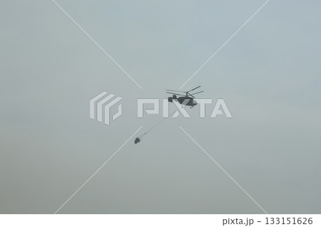 Bucket carrying helicopter. High quality photo Bucket carrying helicopter. High quality photo 133151626