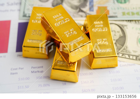 Gold bars on graph paper, finance trading investment business currency. Gold bars on graph paper, finance trading investment business currency. 133153656