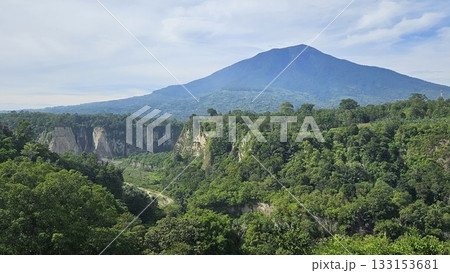 A stunning viewpoint at Panorama Ngarai Sianok showcases lush greenery, towering trees, and a majestic mountain under the clear blue sky, offering a peaceful harmony. A stunning viewpoint at Panorama Ngarai Sianok showcases lush greenery, towering trees, and a majestic mountain under the clear blue sky, offering a peaceful harmony. 133153681