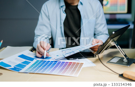 Close up view of UI developer team brainstorming on their project with laptop, smartphone and digital tablet 133154346