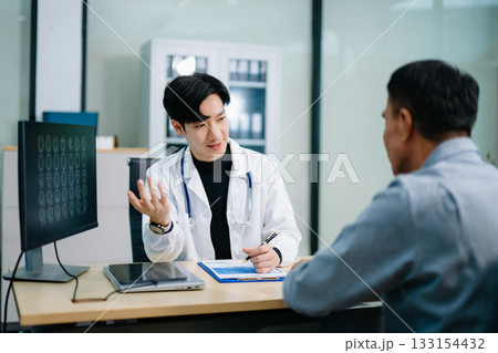 Doctor discusses brain scan results with patient using screen and clipboard. health care, neurology, diagnosis Doctor discusses brain scan results with patient using screen and clipboard. health care, neurology, diagnosis 133154432