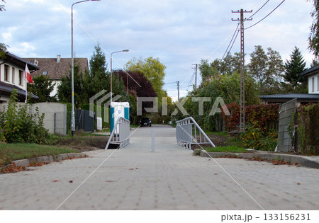 Quiet street view with a gentle slope and greenery in a suburban area during  133156231