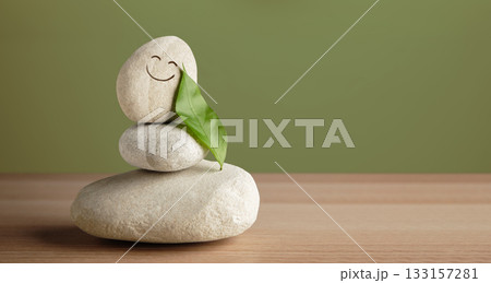 Smiling stone with leaf shows harmony of life, happiness, nature connection Smiling stone with leaf shows harmony of life, happiness, nature connection 133157281