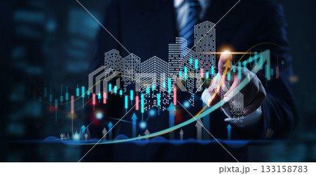 Businessman analyzing real estate investment data with futuristic city skyline and candlestick chart, property growth, market trends, and financial analytics. 133158783