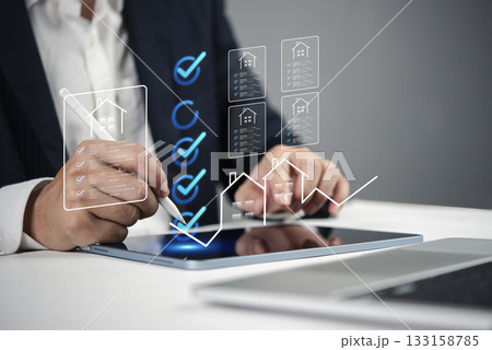 Hand holding stylus, approving virtual property documents, highlighting streamlined real estate transactions and digital contracts. Ideal for real estate tech and smart home concepts. 133158785