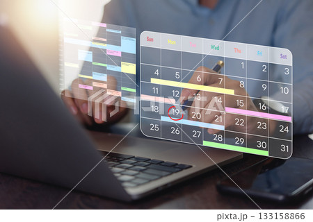 Businessperson planning schedule with digital calendar on laptop. time management, monthly scheduling, productivity tracking. Professional workspace, strategic efficiency, futuristic technology. 133158866