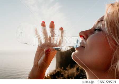 Woman Water Bottle Drinking Ocean Sunset Woman Water Bottle Drinking Ocean Sunset 133159514